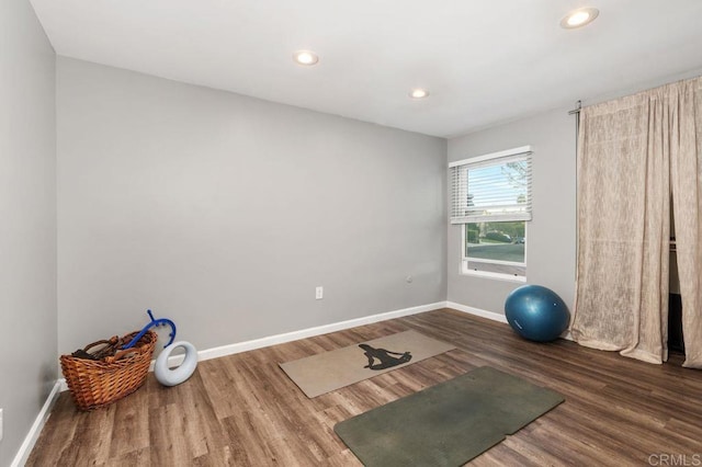 exercise area with dark hardwood / wood-style flooring