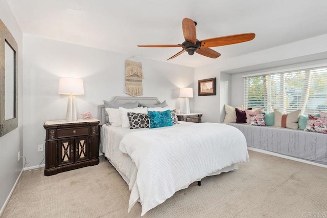 bedroom featuring light colored carpet and ceiling fan