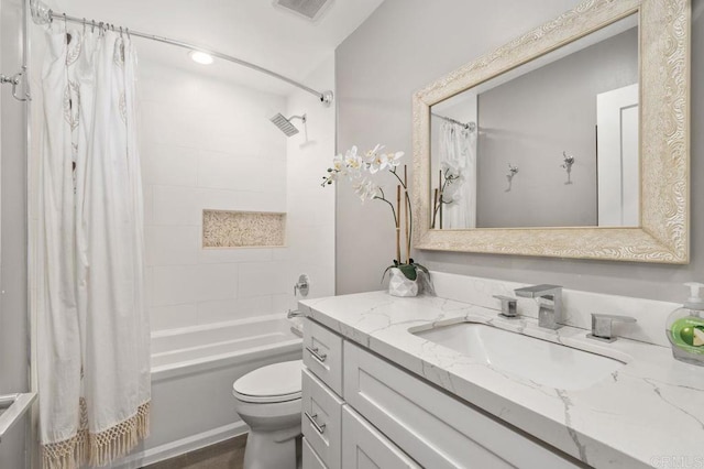 full bathroom with vanity, shower / bath combination with curtain, and toilet