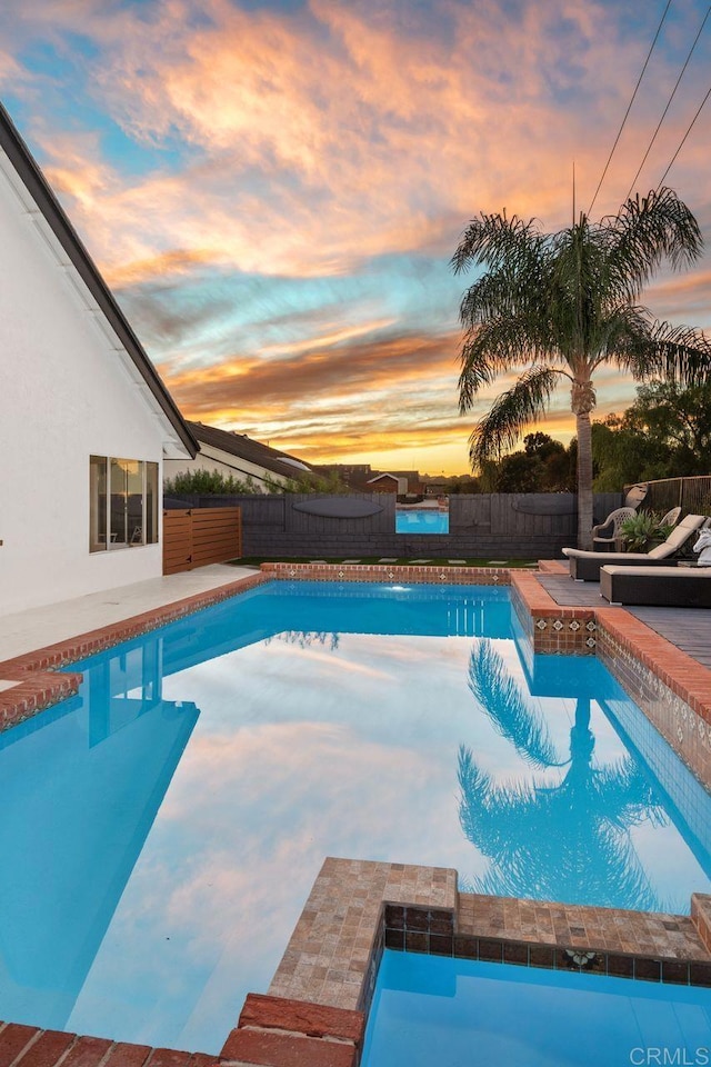 view of pool at dusk