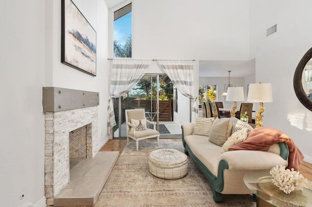 living room featuring light hardwood / wood-style floors and a tiled fireplace