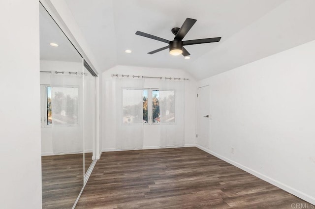 unfurnished bedroom featuring dark wood-type flooring, ceiling fan, and lofted ceiling