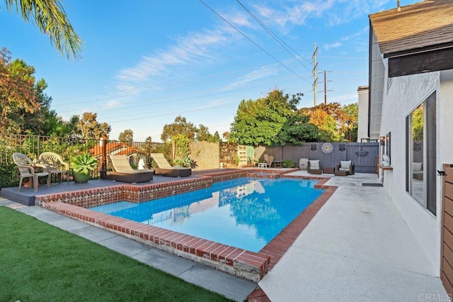 view of swimming pool with a patio