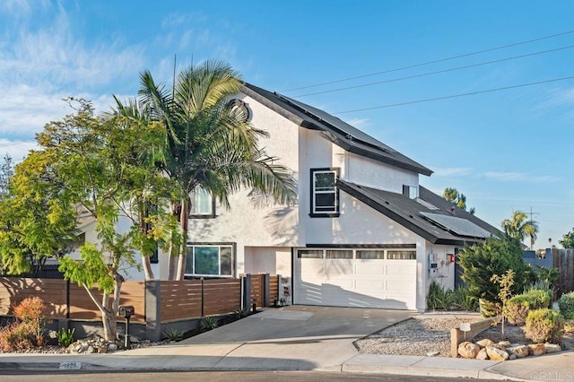 view of front of house with solar panels and a garage