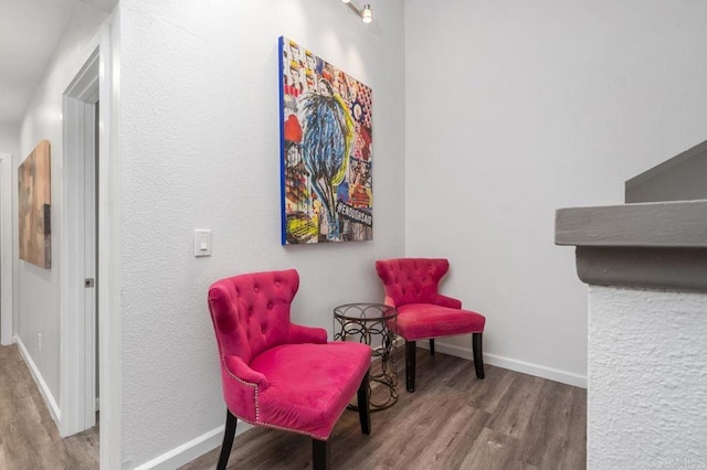 sitting room with hardwood / wood-style flooring