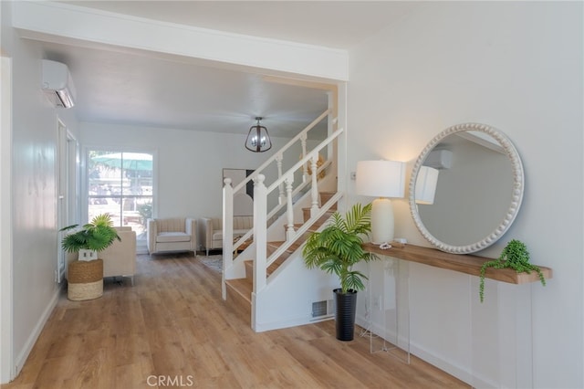 interior space with an inviting chandelier, wood-type flooring, and a wall mounted AC