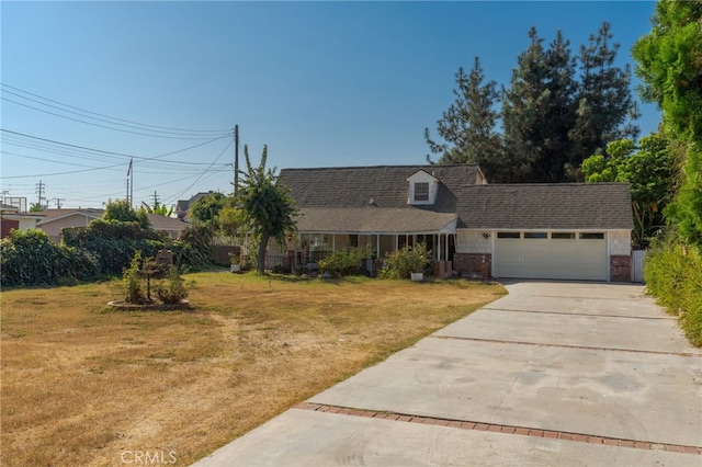 view of front of house featuring a garage and a front lawn