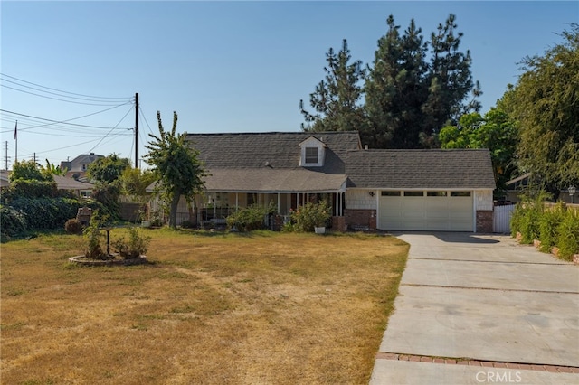 view of front of property with a garage and a front lawn