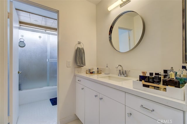 bathroom with vanity and shower / bath combination with glass door