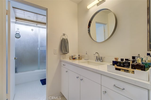 full bathroom with combined bath / shower with glass door and vanity