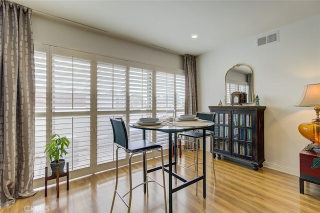 dining area with recessed lighting, wood finished floors, visible vents, and baseboards