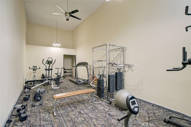 workout area featuring ceiling fan and high vaulted ceiling