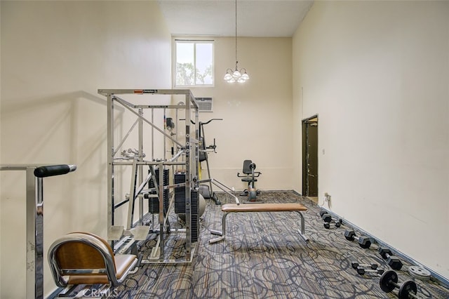 exercise area with an inviting chandelier