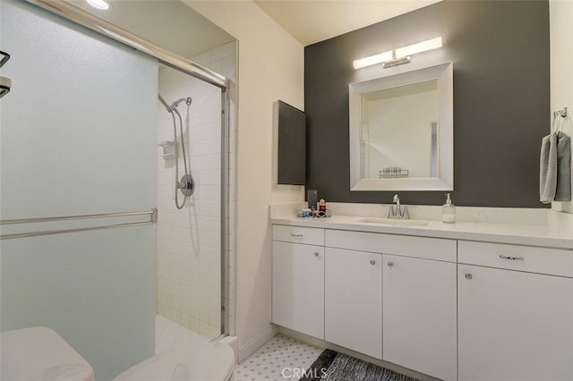 bathroom featuring vanity, toilet, and an enclosed shower