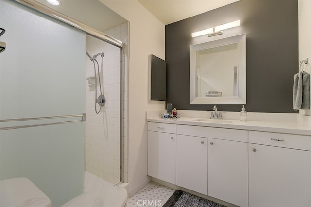 full bathroom featuring a stall shower, vanity, and toilet