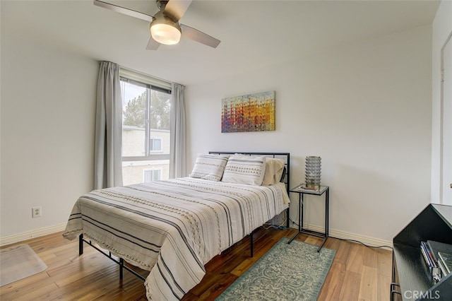 bedroom with hardwood / wood-style flooring and ceiling fan