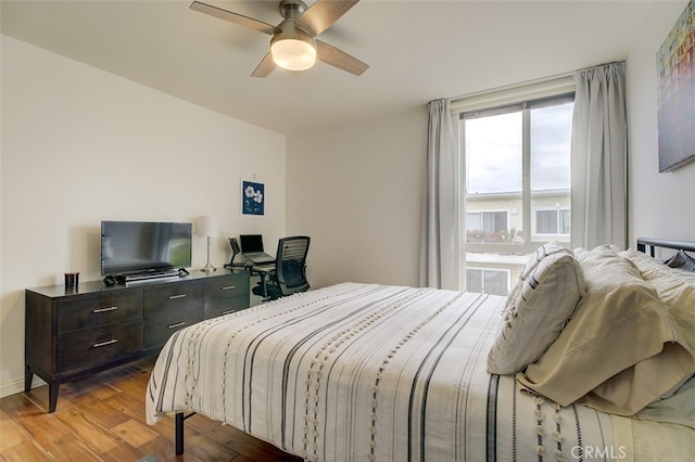 bedroom with ceiling fan and light hardwood / wood-style floors