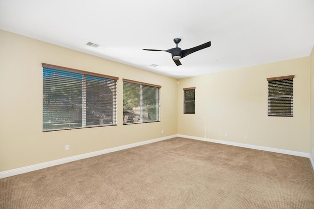 carpeted empty room featuring ceiling fan