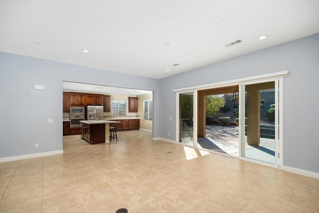 unfurnished living room featuring light tile patterned floors