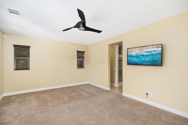 carpeted spare room with ceiling fan