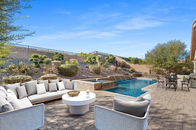 view of pool with outdoor lounge area, a patio area, an in ground hot tub, and pool water feature