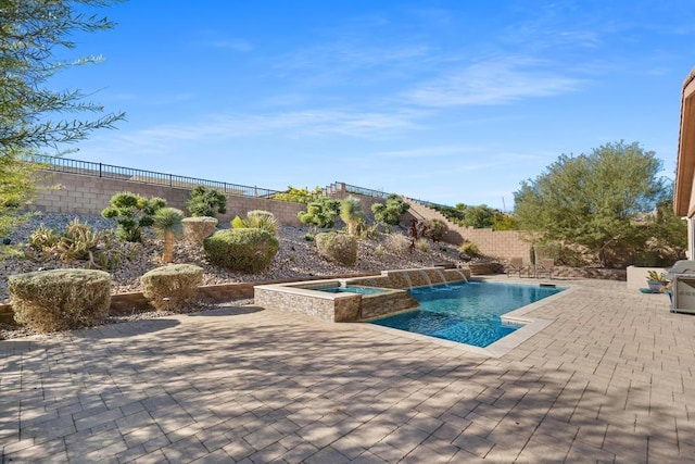 view of pool with an in ground hot tub and a patio area