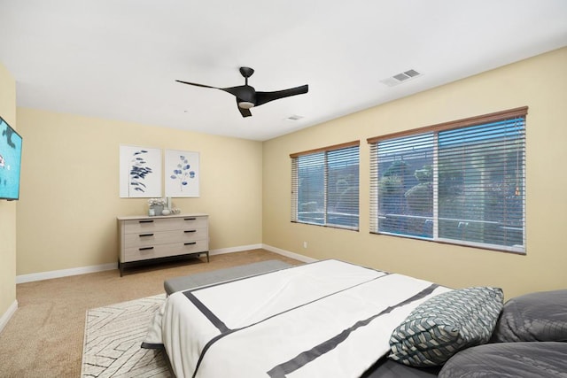 bedroom featuring ceiling fan and light colored carpet