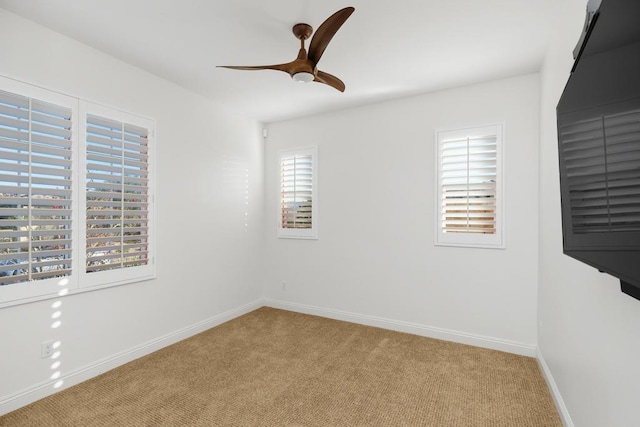 unfurnished room featuring light colored carpet, plenty of natural light, and ceiling fan