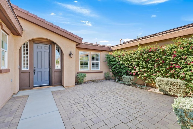 entrance to property featuring a patio area