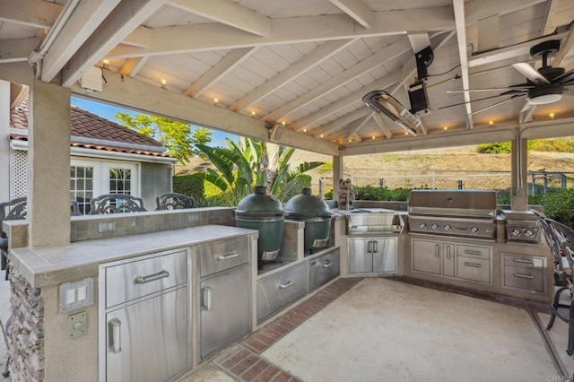 view of patio / terrace featuring a gazebo, ceiling fan, a grill, and exterior kitchen