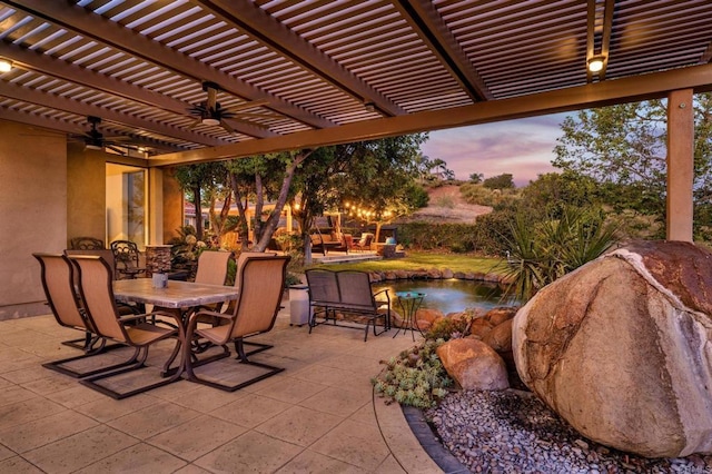 patio terrace at dusk with a pergola and ceiling fan