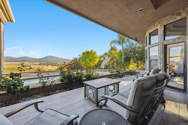 wooden terrace featuring a mountain view