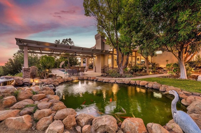 exterior space featuring a garden pond