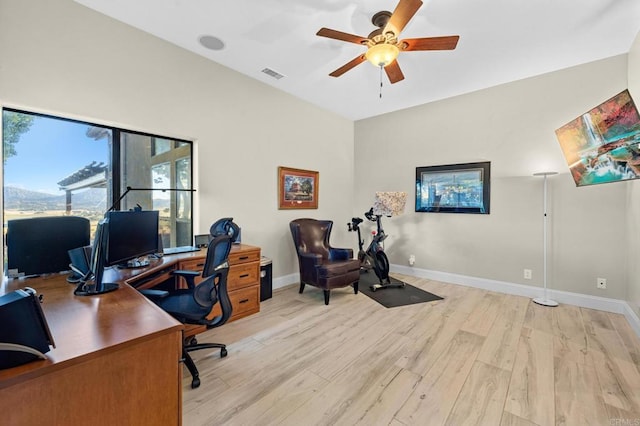 home office with ceiling fan and light hardwood / wood-style floors