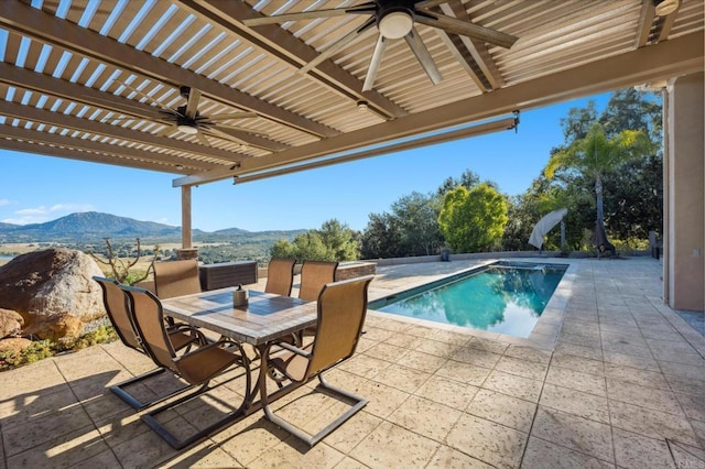 view of swimming pool with a mountain view, ceiling fan, and a patio