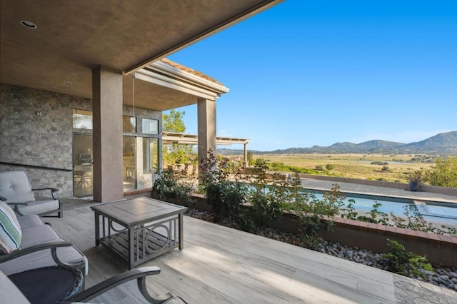 wooden deck with a mountain view