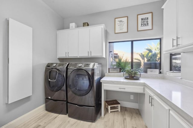 washroom with cabinets, separate washer and dryer, and light hardwood / wood-style flooring