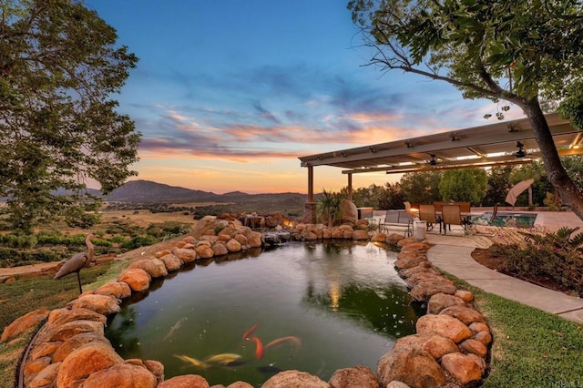 property view of water featuring a small pond and a mountain view