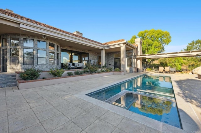 view of swimming pool with an in ground hot tub and a patio