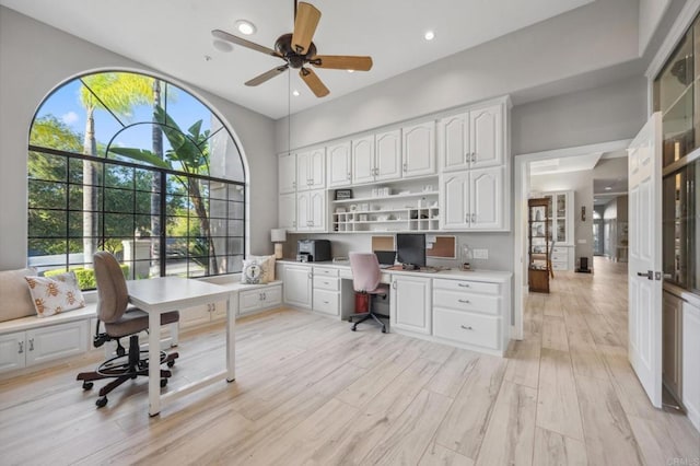 office space with recessed lighting, a high ceiling, ceiling fan, and light wood finished floors