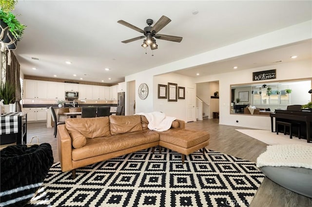 living room featuring hardwood / wood-style flooring and ceiling fan