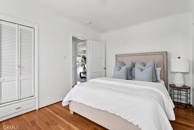 bedroom with hardwood / wood-style flooring and a closet