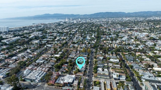 birds eye view of property with a water and mountain view