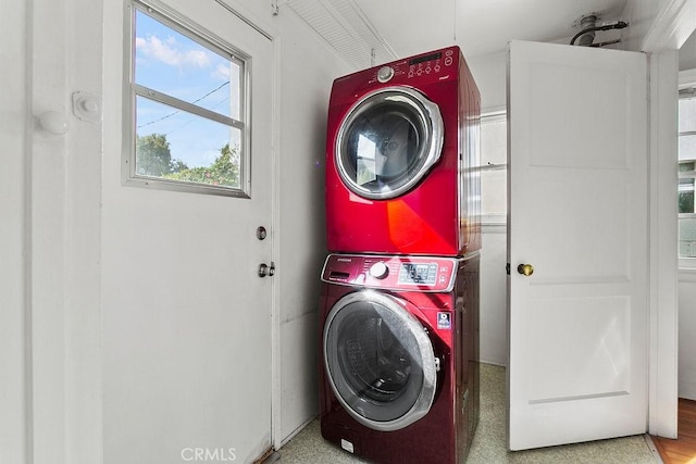 laundry area with stacked washer / dryer