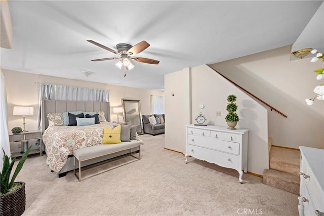 bedroom with ceiling fan and light colored carpet