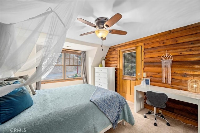 carpeted bedroom with ceiling fan and built in desk