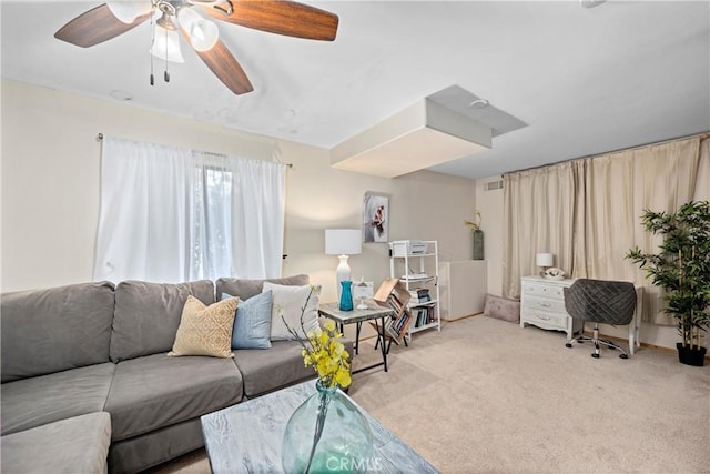 carpeted living room with ceiling fan