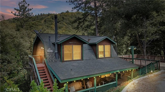 view of back house at dusk