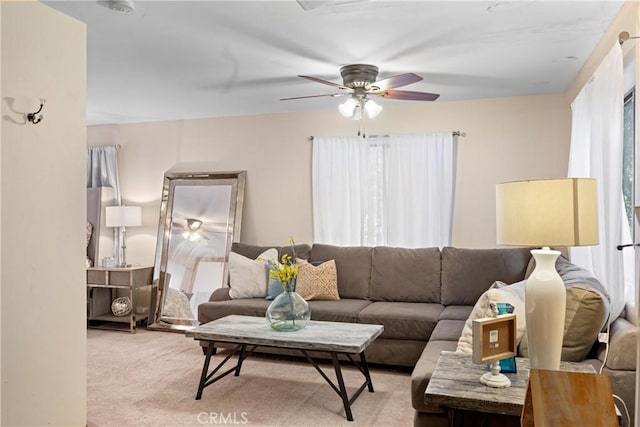 carpeted living room featuring ceiling fan