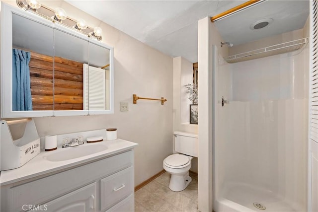 bathroom with a shower, vanity, and toilet